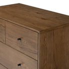 Close up of Four Hands Eaton 5 Drawer Dresser in Amber Oak Resin on a white background at Addison West