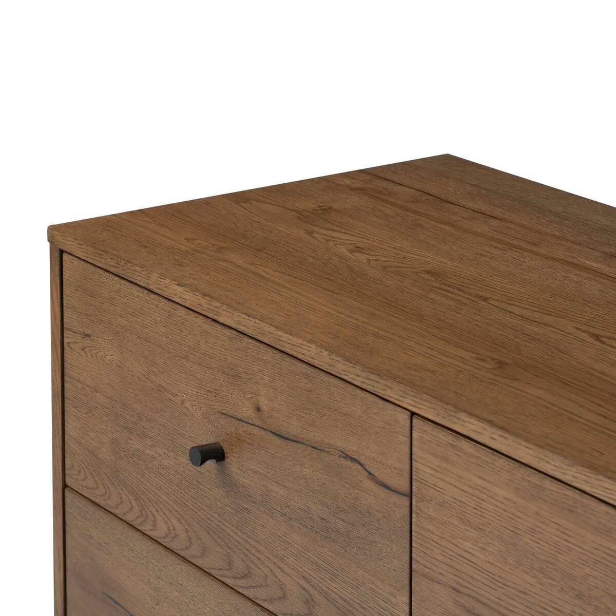 Close up of Four Hands Eaton 5 Drawer Dresser in Amber Oak Resin on a white background at Addison West