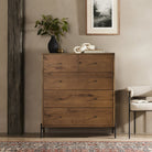 Four Hands Eaton 5 Drawer Dresser in Amber Oak Resin in a beige room  at Addison West