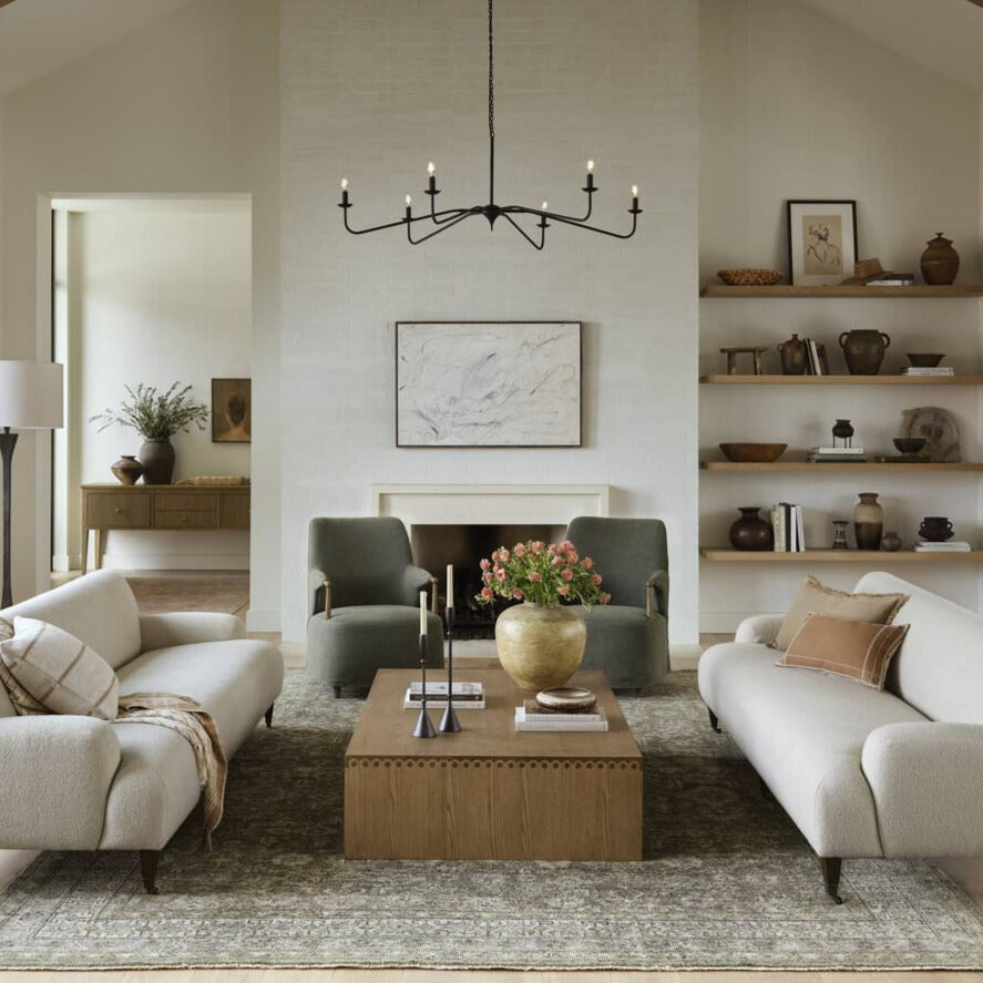 Four Hands Edlyn Chandelier in Antiqued Iron in a light modern neutral living room