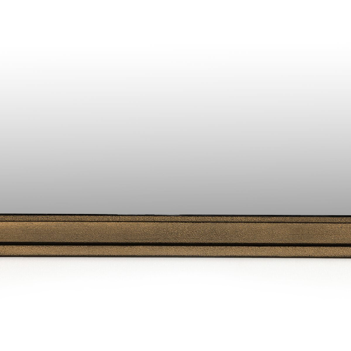 Close up of Four Hands Effie Mirror in Raw Antique Brass on a white background at Addison West