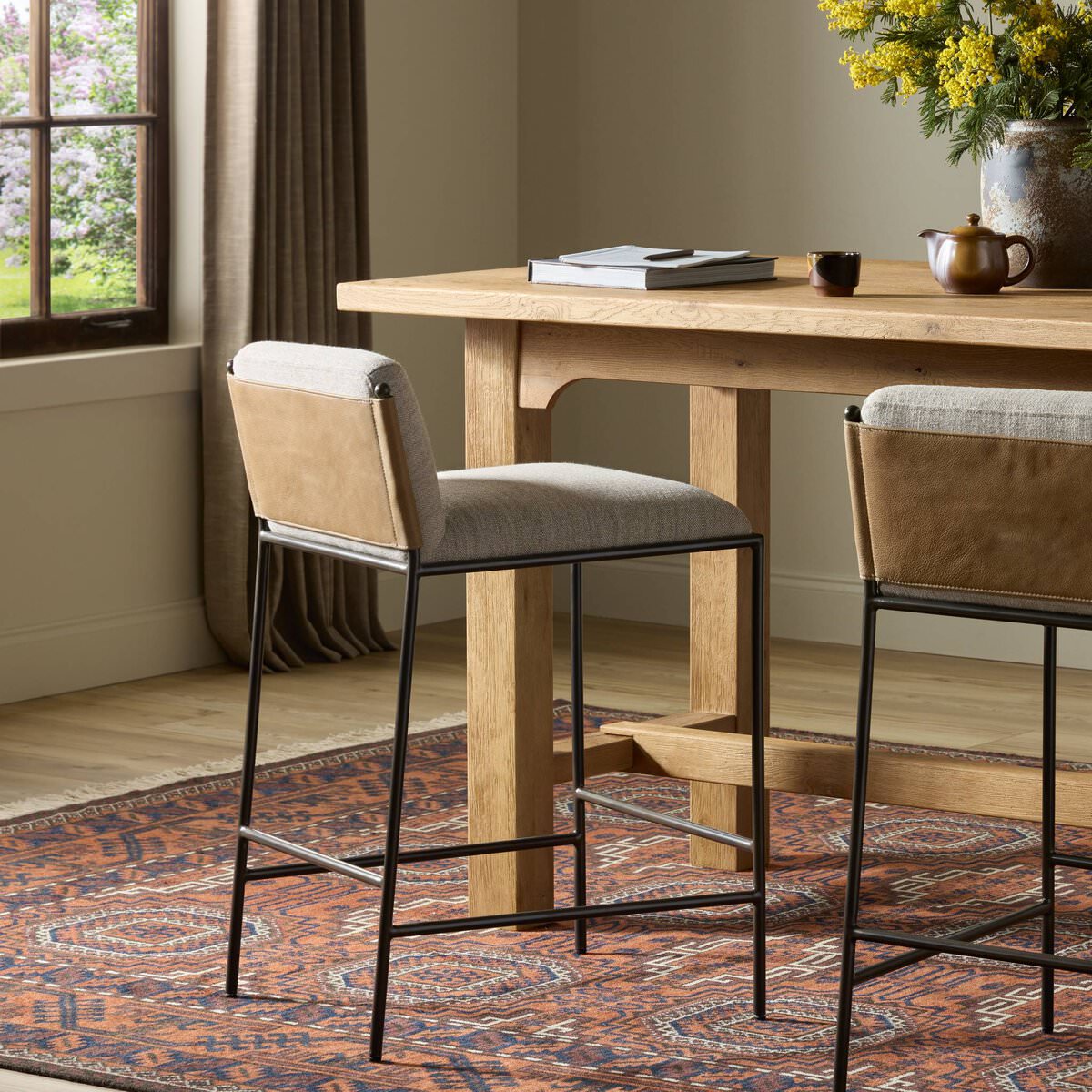 Four Hands Elba Counter Stool in Alcala Wheat in a dining room at Addison West