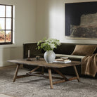 Four Hands Elio Coffee Table Small in Burnt Bleached Oak in a neutral living room at Addison West