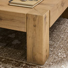 Close up of Four Hands Emmer Coffee Table in Aged Smoked Oak in a living room at Addison West