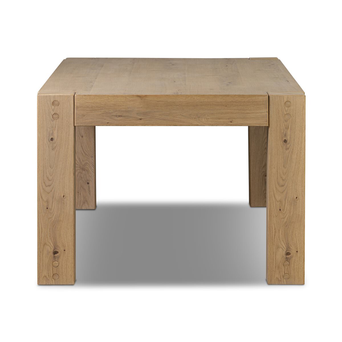 Four Hands Emmer Dining Table in Aged Smoked Oak on a white background at Addison West
