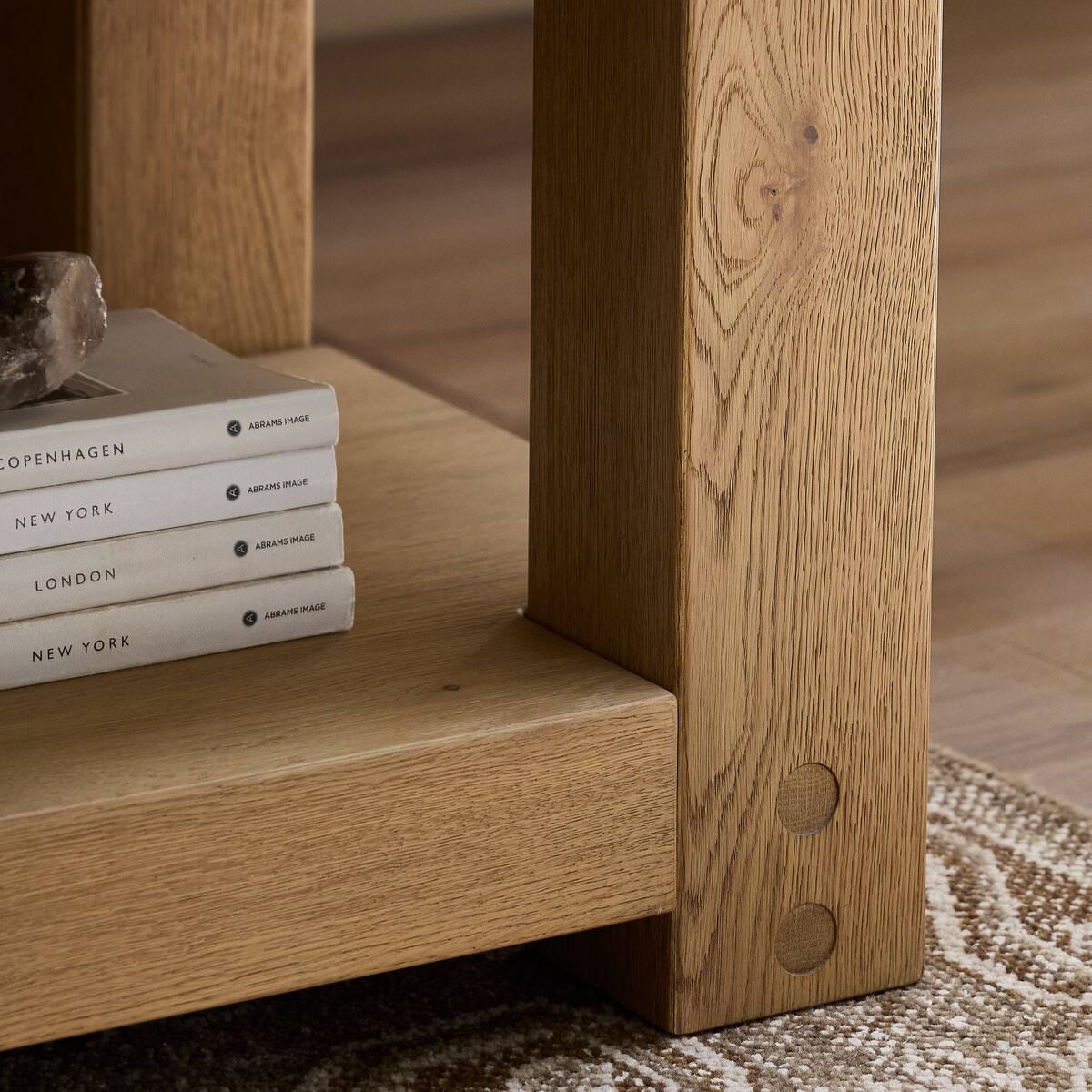 Close up of Four Hands Emmer End Table in Aged Smoked Oak in a living room at Addison West