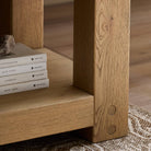 Close up of Four Hands Emmer End Table in Aged Smoked Oak in a living room at Addison West