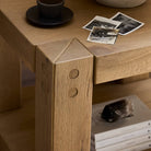 Close up of Four Hands Emmer End Table in Aged Smoked Oak in a living room at Addison West