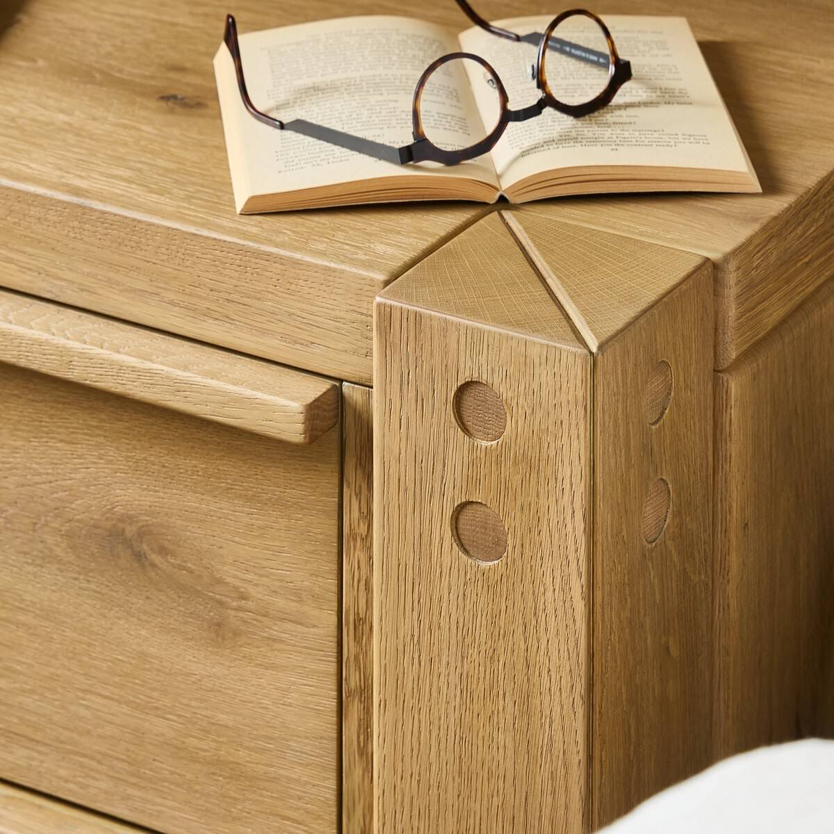 Close up of Four Hands Emmer Nightstand in Aged Smoked Oak in a bedroom at Addison West
