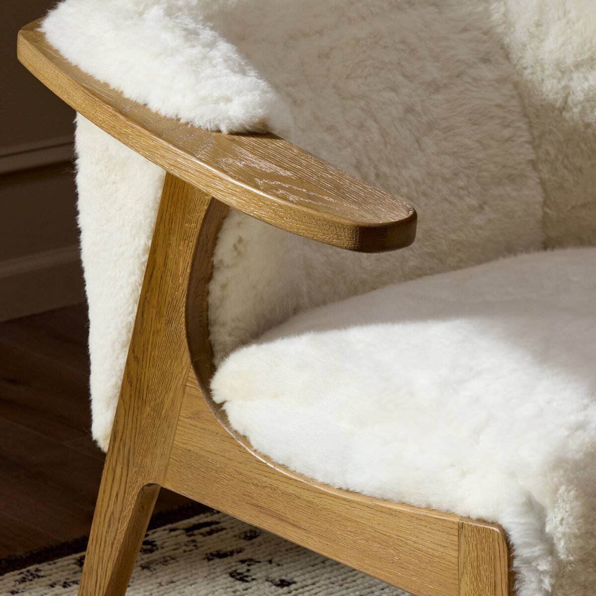 Close up of Four Hands Fabian Chair in Cream Shearling in a living room at Addison West