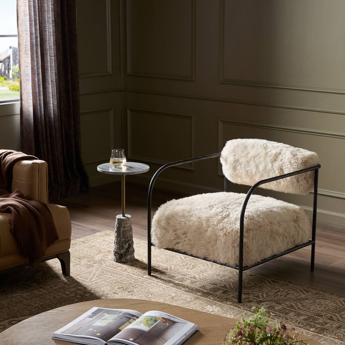 Four Hands Fenn Chair in Champagne Mongolian Fur in a green living room at Addison West