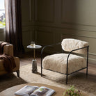 Four Hands Fenn Chair in Champagne Mongolian Fur in a green living room at Addison West