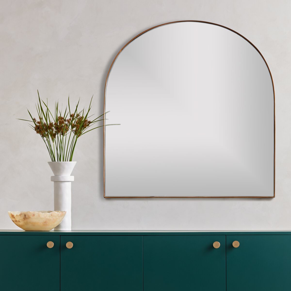 Four Hands Georgina Wide Mirror in Polished Brass above a table at Addison West