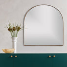 Four Hands Georgina Wide Mirror in Polished Brass above a table at Addison West
