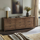 Four Hands Glenview 9 Drawer Dresser in Weathered Oak Veneer in a beige bedroo at Addison West