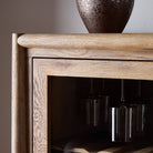 Close up of Four Hands Glenview Bar Cabinet in Weathered Oak on a white background at Addison West