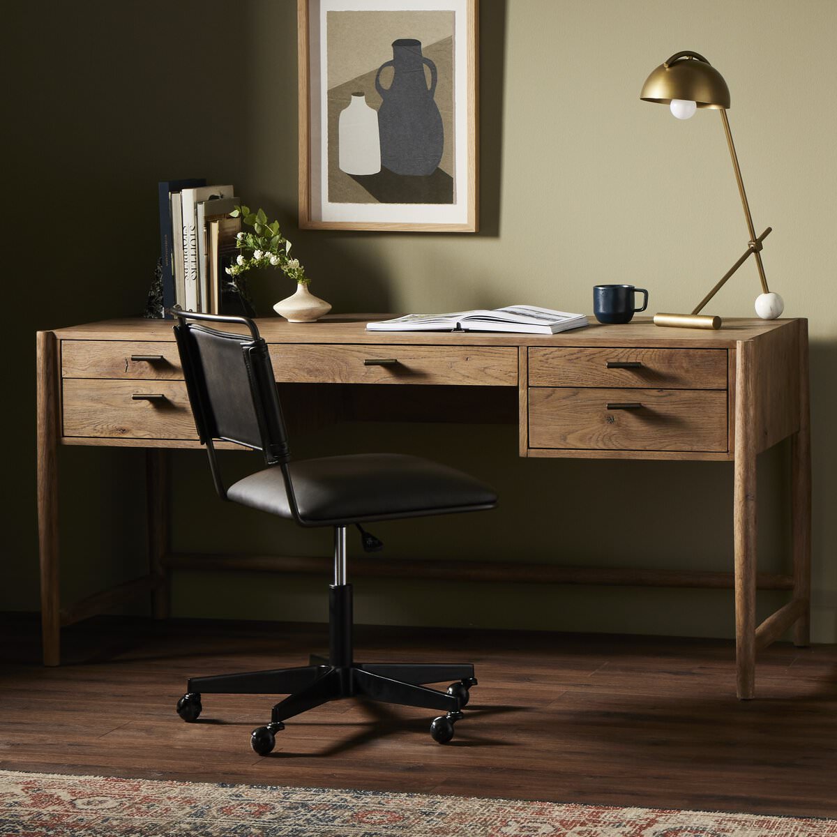 Four Hands Glenview Desk in Weathered Oak Veneer in a modern office with green walls