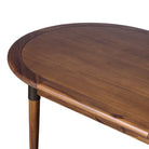 Close up of Four Hands Harper Oval Extension Dining Table 84-104" in Toasted Walnut on a white background at Addison West