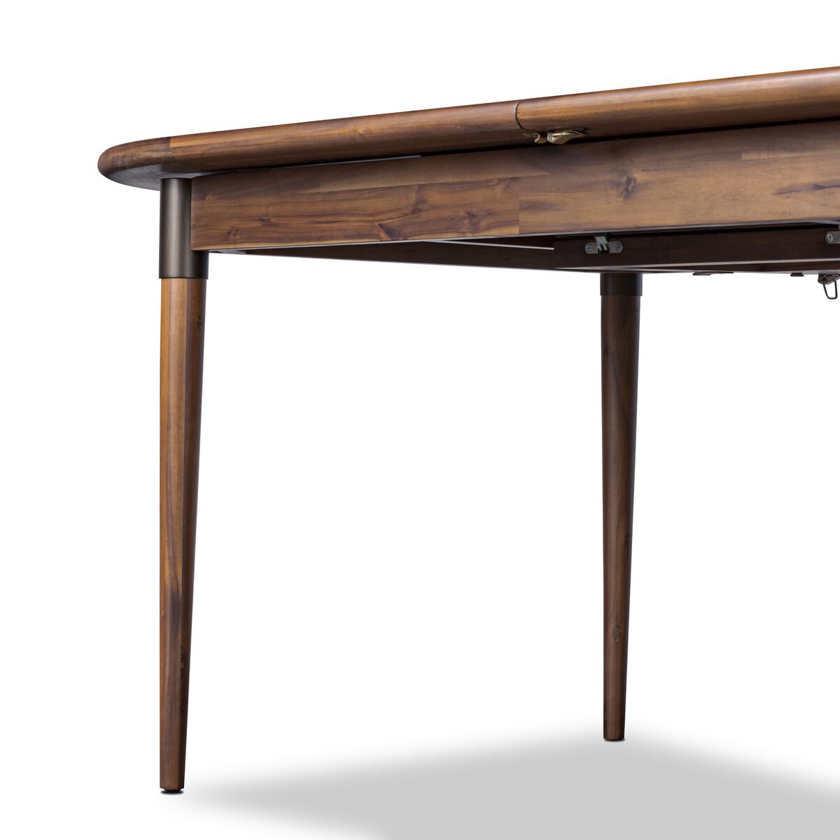 Close up of Four Hands Harper Oval Extension Dining Table 84-104" in Toasted Walnut on a white background at Addison West