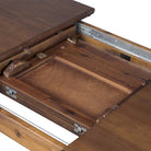 Close up of Four Hands Harper Oval Extension Dining Table 84-104" in Toasted Walnut on a white background at Addison West