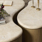 Close up of Four Hands Ingrid Coffee Table in Cappuccino Marble against a rug at Addison West