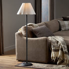 Four Hands Isabeau Floor Lamp in Black Wrought Iron in a living room at Addison West