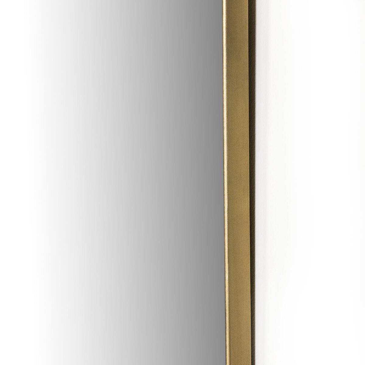 Close up of Four Hands Jacques Mirror in Antique Brass on a white background at Addison West