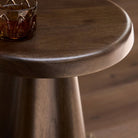 Close up of Four Hands Jinx End Table in Tawny Mango in a living room at Addison West