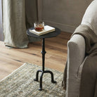 Four Hands Jocelyn End Table Raw Black Iron in a neutral living room