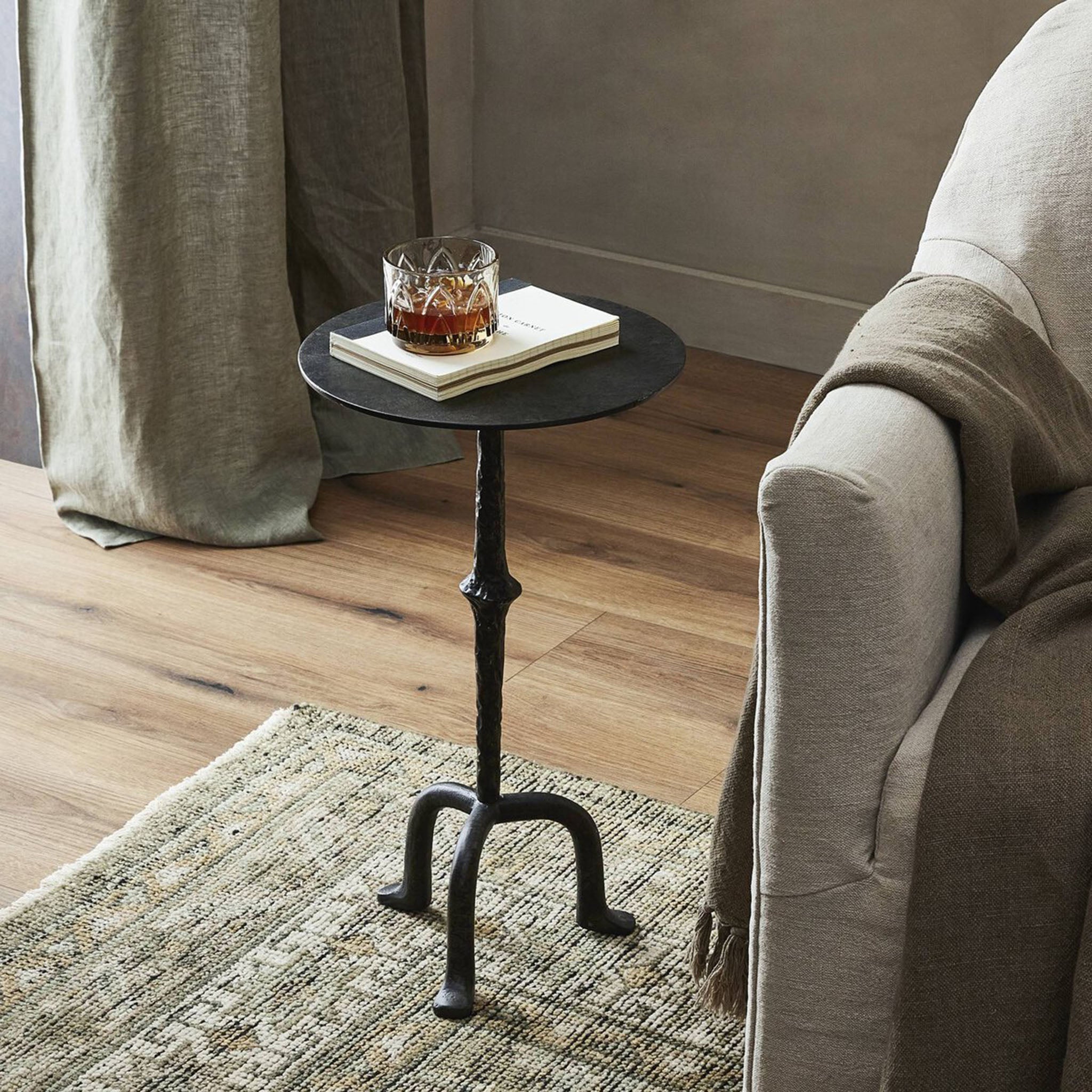 Four Hands Jocelyn End Table Raw Black Iron in a neutral living room
