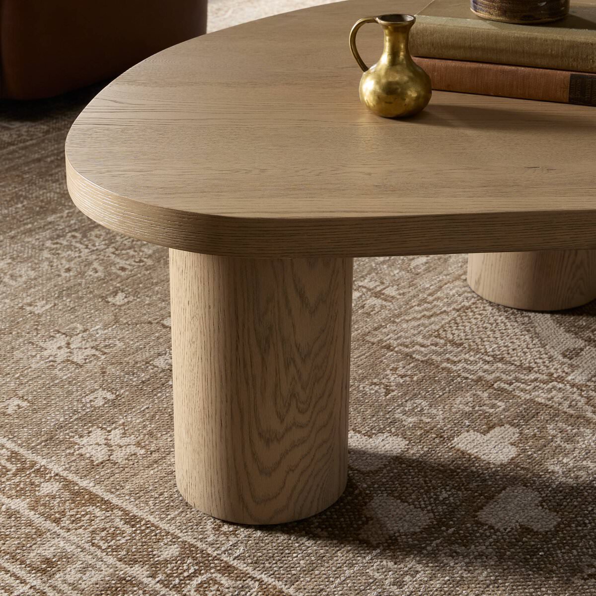 Close up of Four Hands Joji Nesting Coffee Table in Natural Oak Veneer in Large in a living room at Addison West