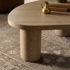 Close up of Four Hands Joji Nesting Coffee Table in Natural Oak Veneer in Large in a living room at Addison West