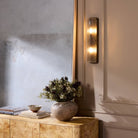 Four Hands Kenji Sconce in Clear Reeded Glass on a wall at Addison West