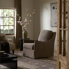 Four Hands Monette Glider Swivel in Broadway Coffee in a living room at Addison West