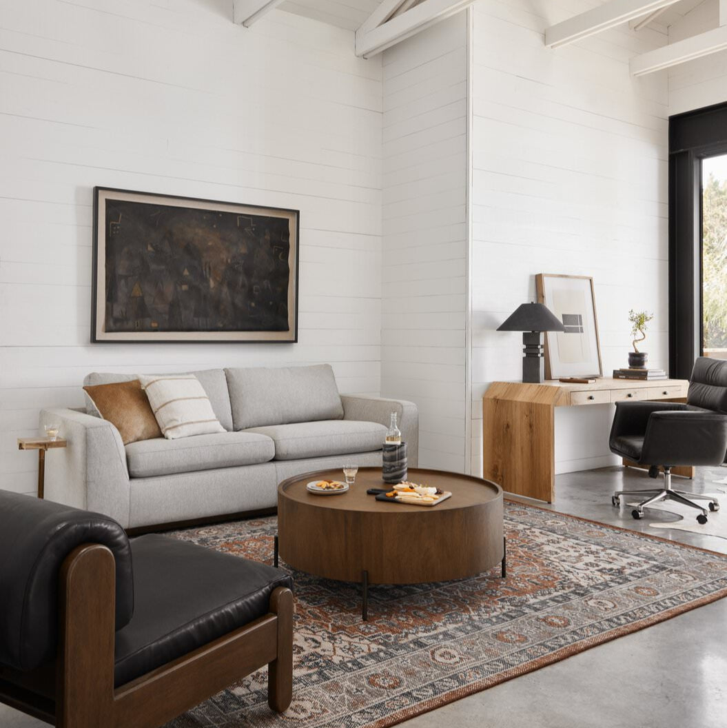 Four Hands Prato Hand Knotted Rug in Prato in a white walled living room at Addison West