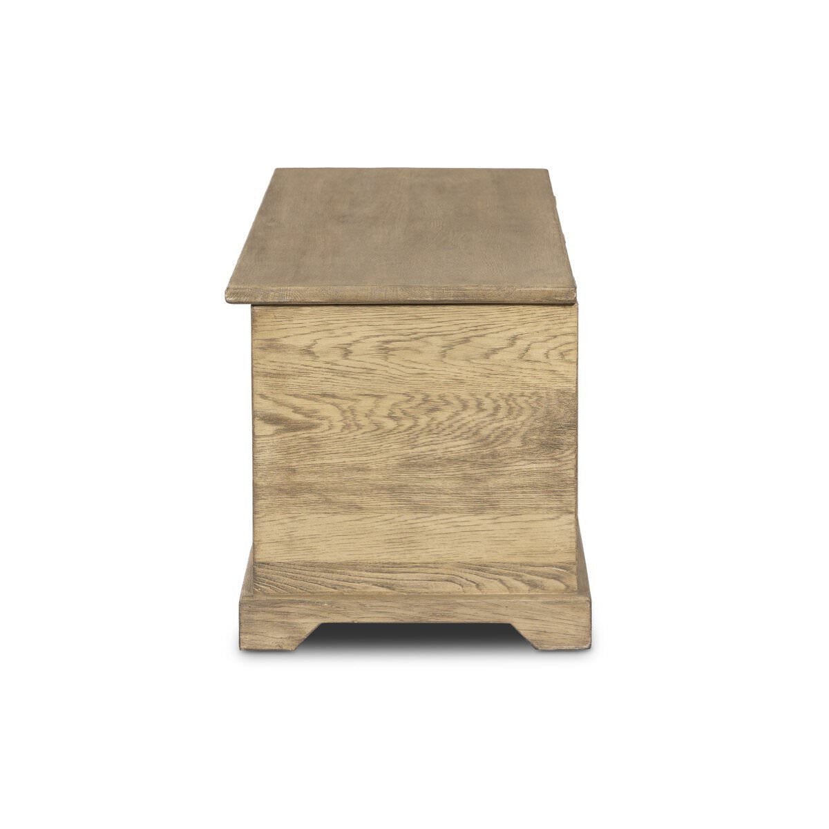 Side of Four Hands Quintin Trunk in Worn Oak on a white background at Addison West