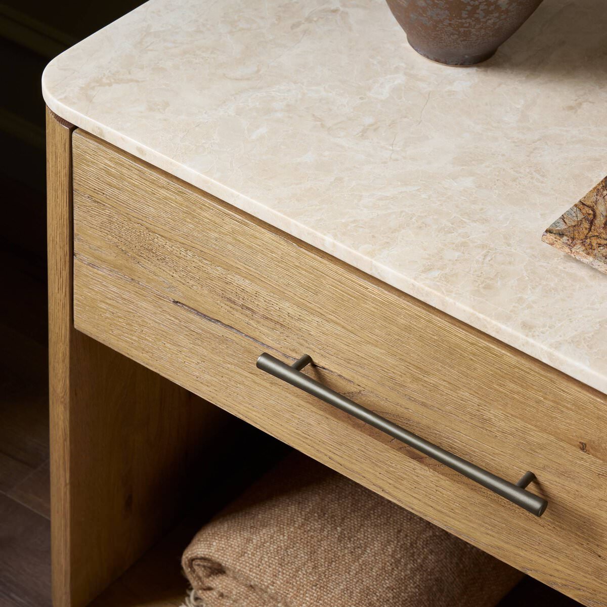 Close up of Four Hands Raleigh Nightstand in Cappuccino Marble in a bedroom at Addison West