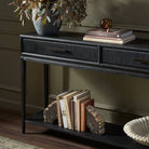 Close up of Four Hands Rosenell Console Table 60" in Black Oak Solid in a living room at Addison West