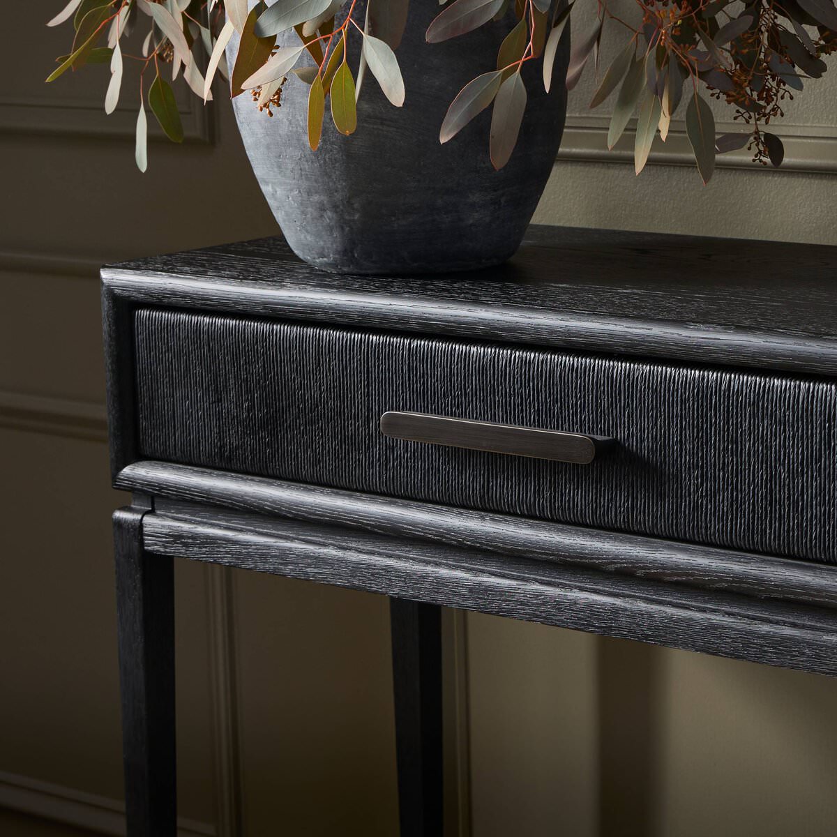 Close up of Four Hands Rosenell Console Table 60" in Black Oak Solid in a living room at Addison West