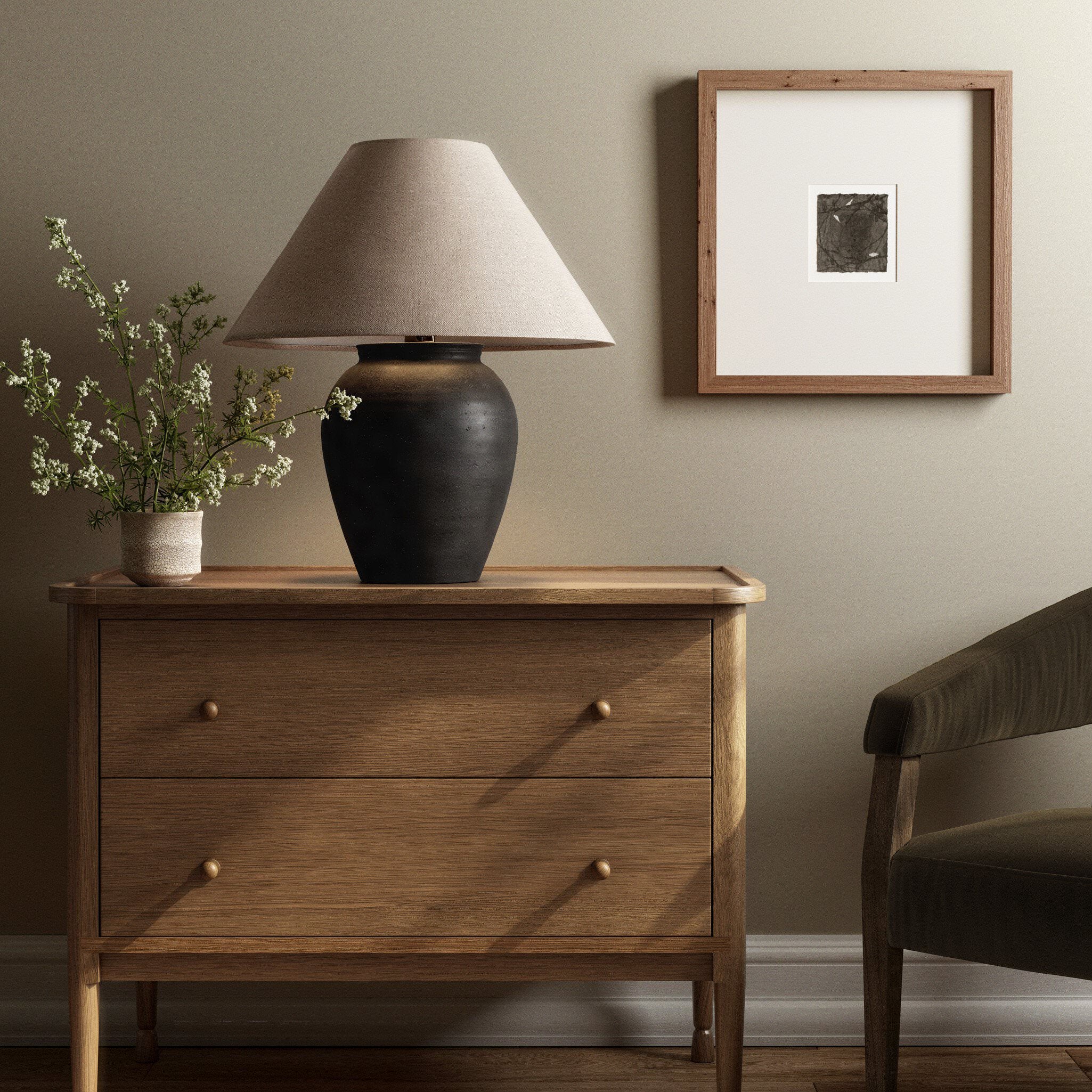 Four Hands Russo Table Lamp in Aged Black Terracotta on a table at Addison West