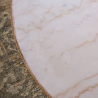 Close up of Four Hands Sargon Dining Table in Honed White Marble in a dining room at Addison West