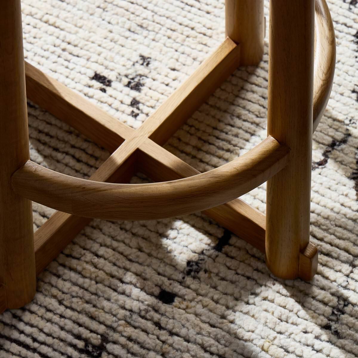 Close up of Four Hands Staria Swivel Counter Stool in Saxon Sand in a dining room at Addison West