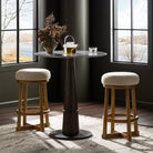 Four Hands Staria Swivel Counter Stool in Saxon Sand in a dining room at Addison West