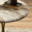 Close up of Four Hands Sylas End Table in Fossil Marble in a living room at Addison West