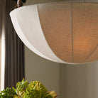 Close up of Four Hands Teague Pendant in Antique Brass Iron in a dining room at Addison West