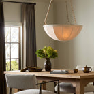 Four Hands Teague Pendant in Antique Brass Iron in a dining room at Addison West