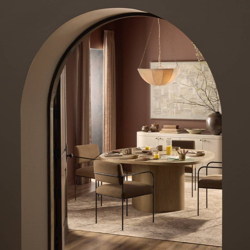 Four Hands Teague Pendant in Antique Brass Iron in a dining room at Addison West