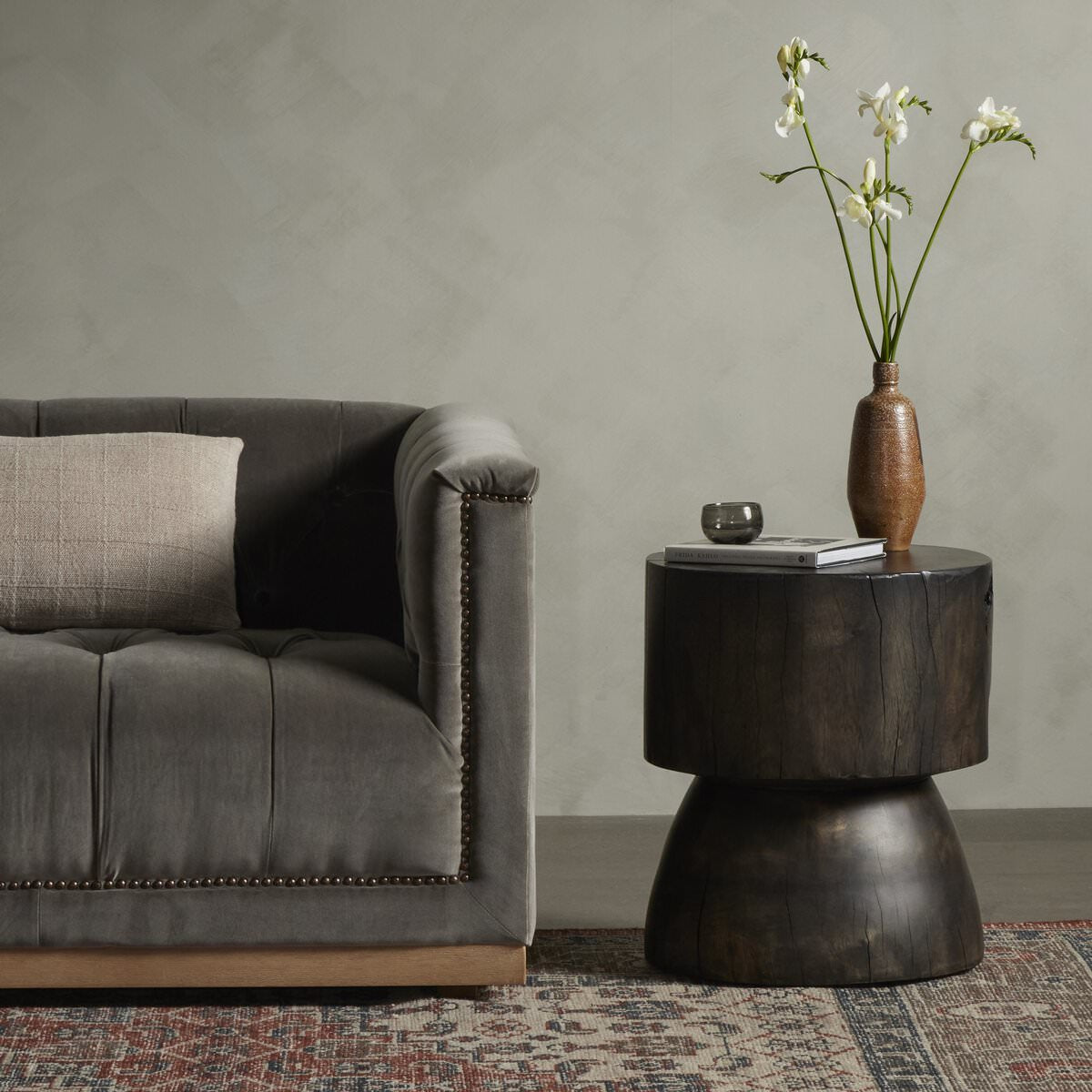 Four Hands Tino End Table in Rubbed Black in a modern neutral dark living room