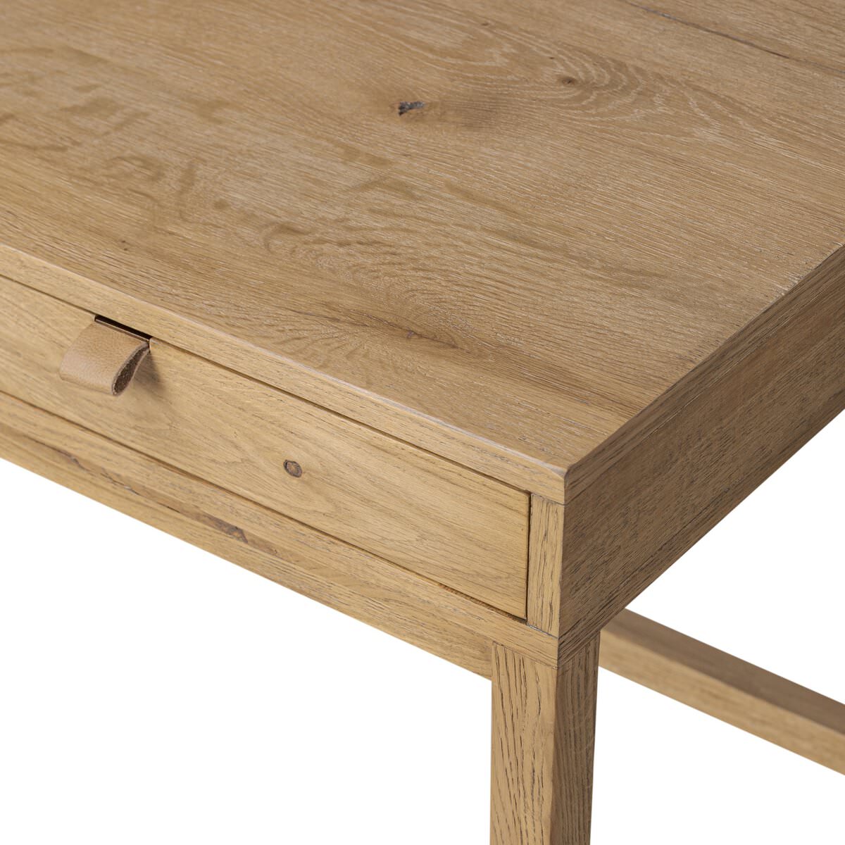 Close up of Four Hands Tula Writing Desk in Worn Oak Veneer on a white background at Addison West