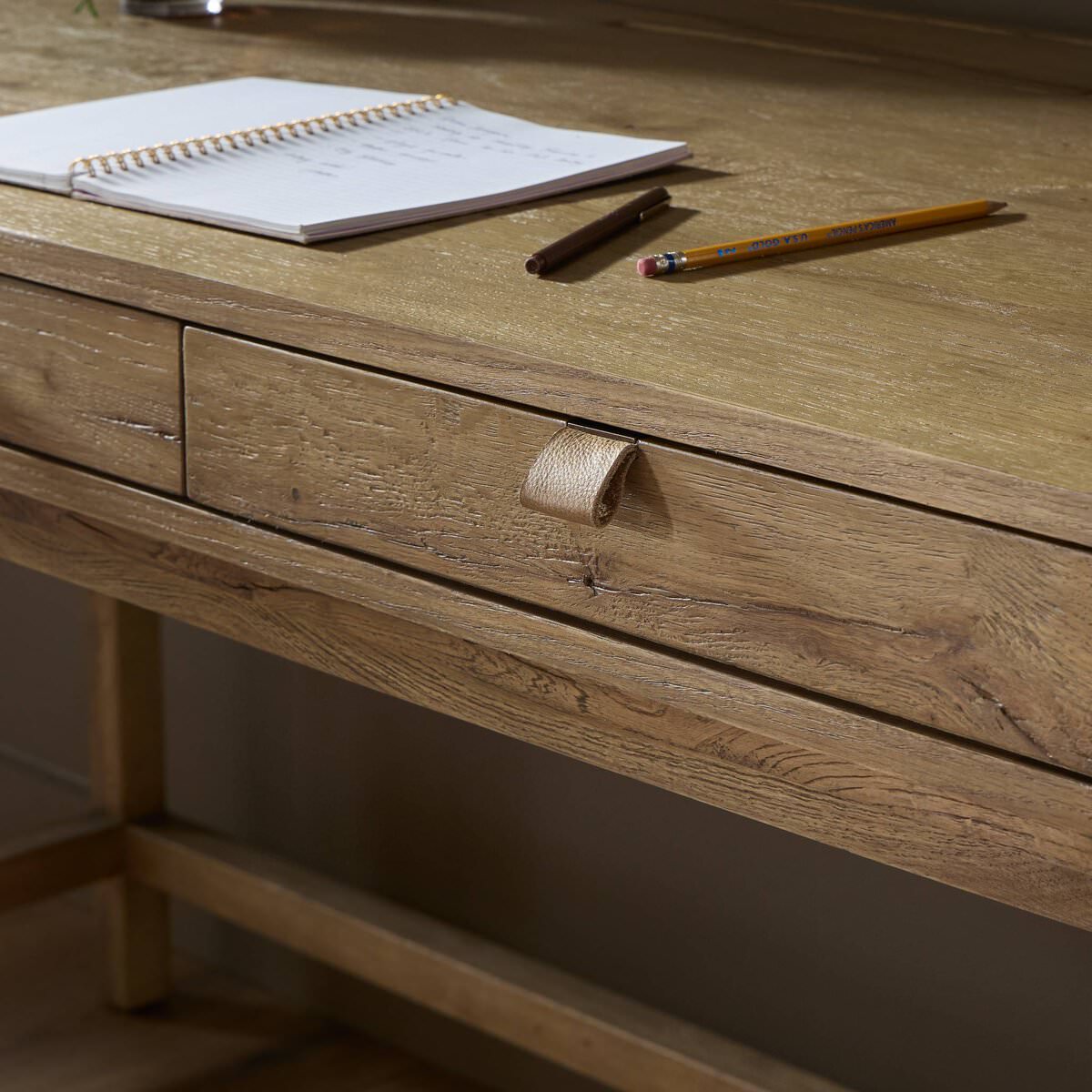 Close up of Four Hands Tula Writing Desk in Worn Oak Veneer on a white background at Addison West